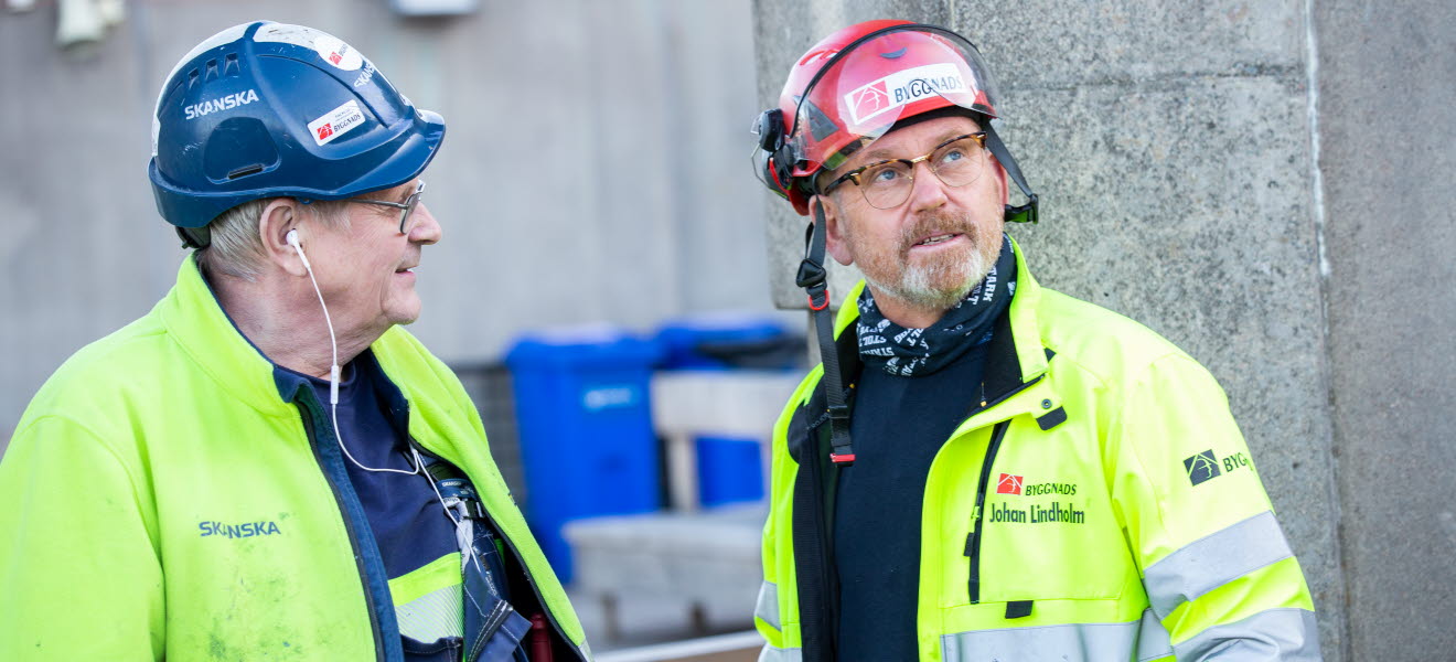 Johan Lindholm i samtal med byggnadsarbetare.